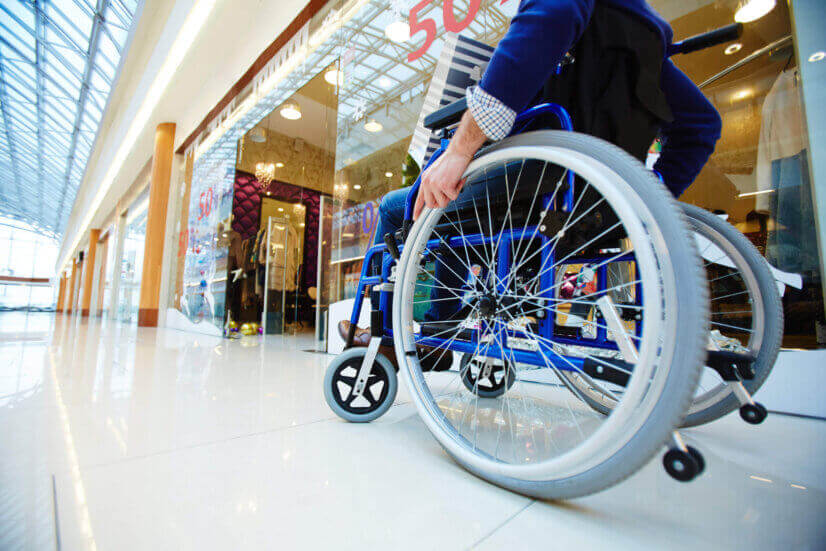 man using a wheelchair in mall