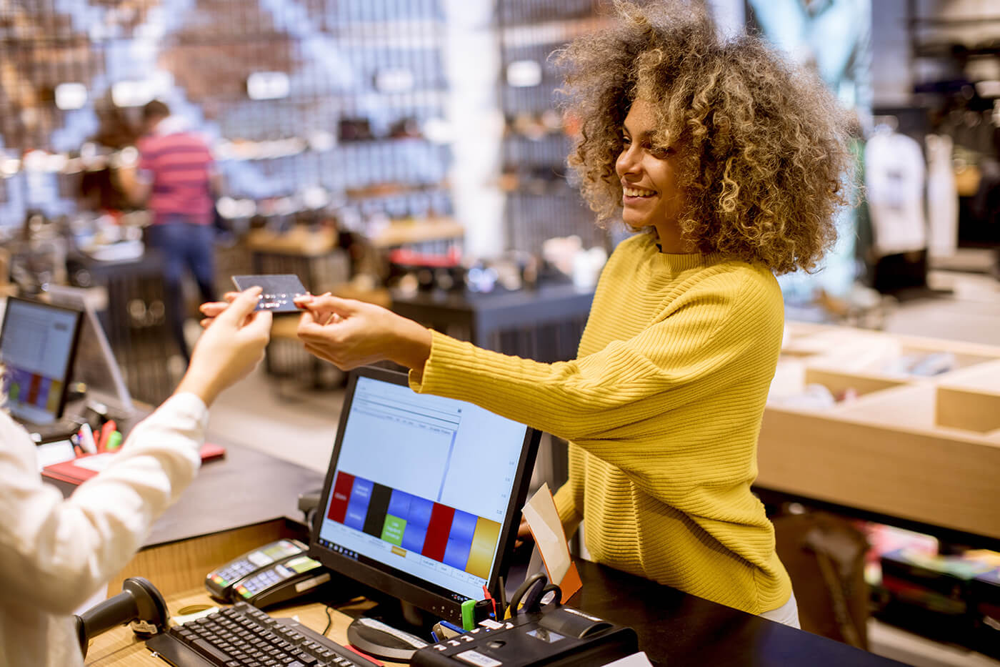 woman customer paying with credit card in retail store