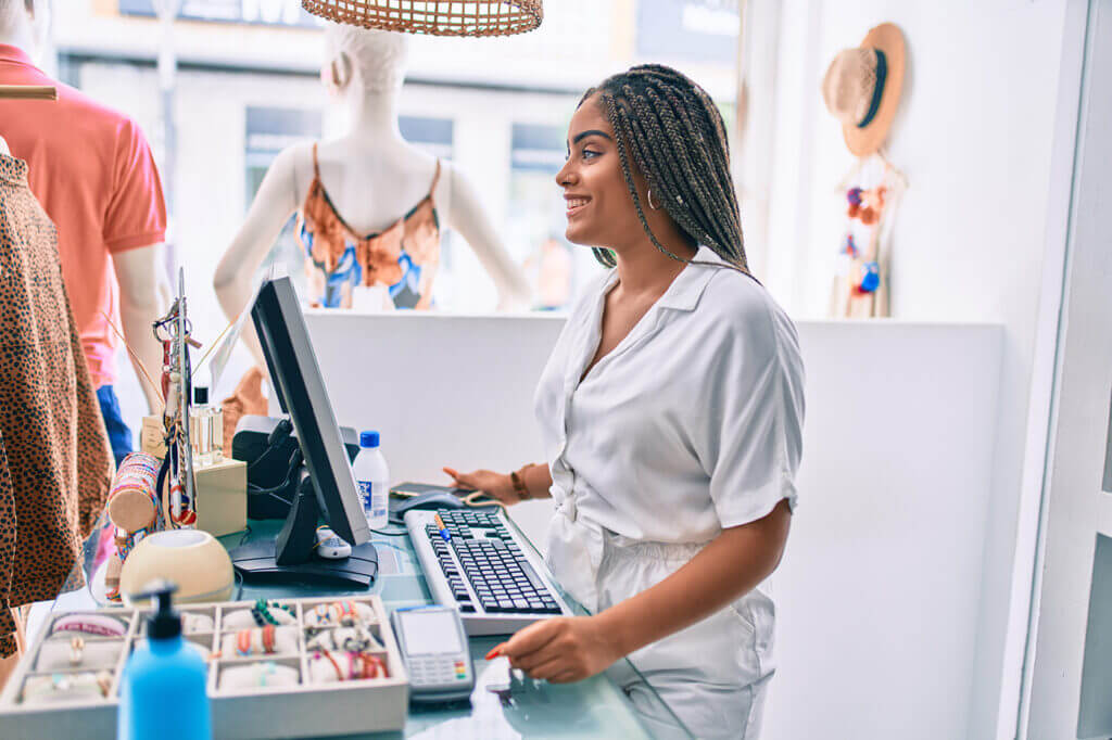 retail worker behind the counter of the register