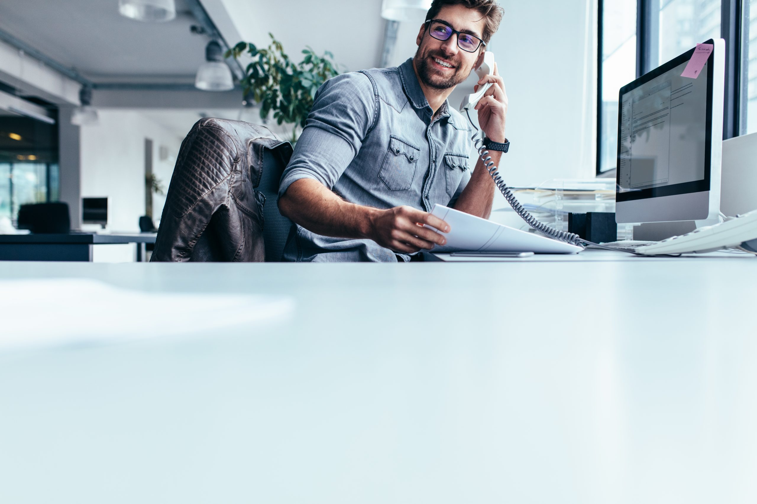 businessman talking on landline at office