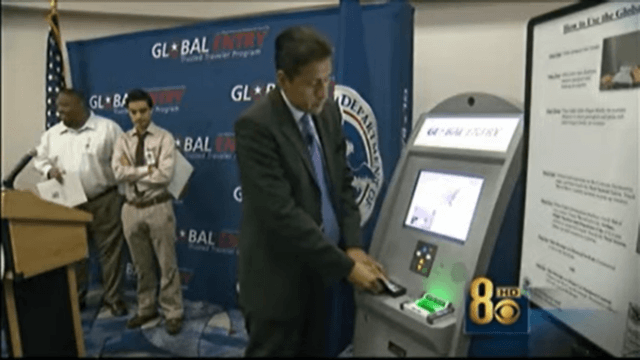 Man showcasing how to use a global entry kiosk