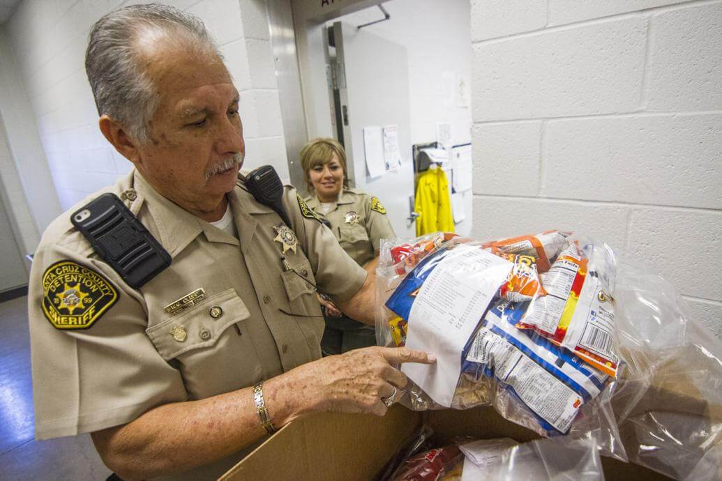 detenion officer reading commissary receipt