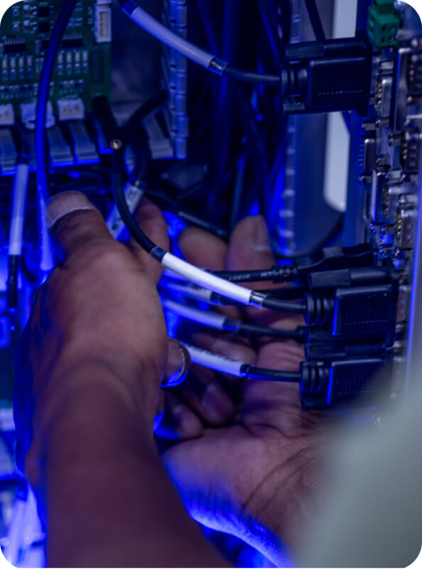technician working on cords in a server