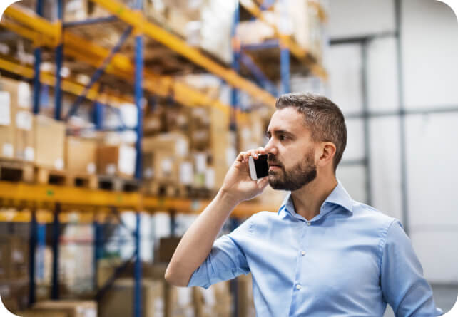 man on phone in warehouse