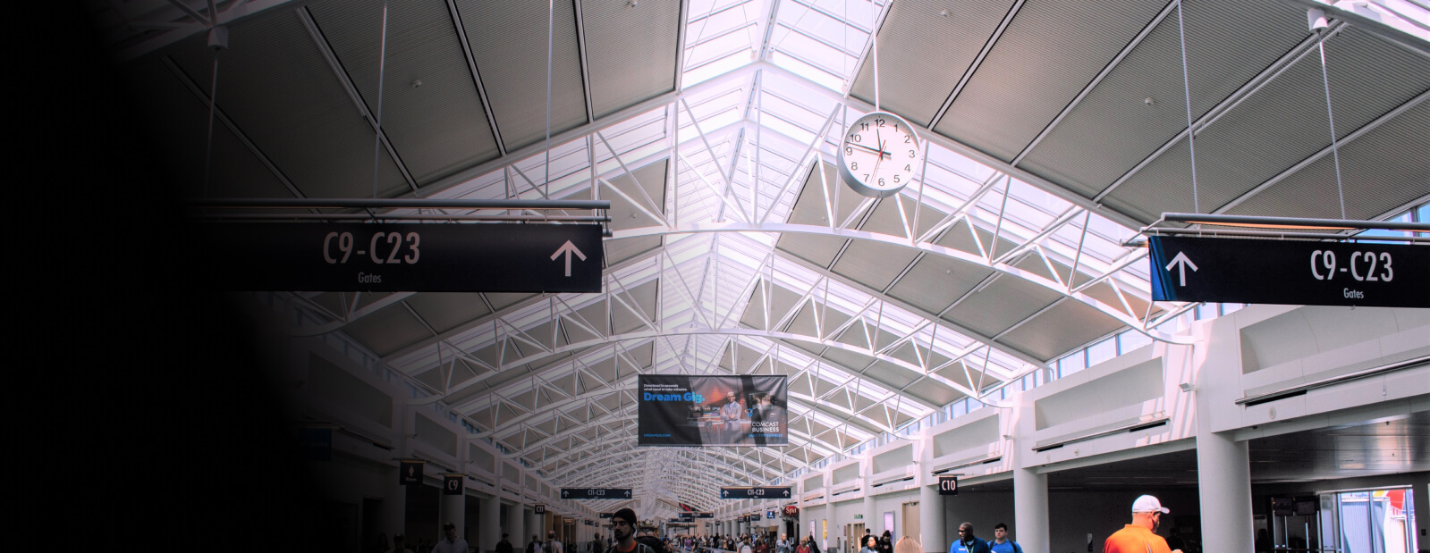 The ceiling of an airport terminal, showing the directs to airport gates