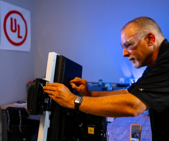 technician working on a kiosk