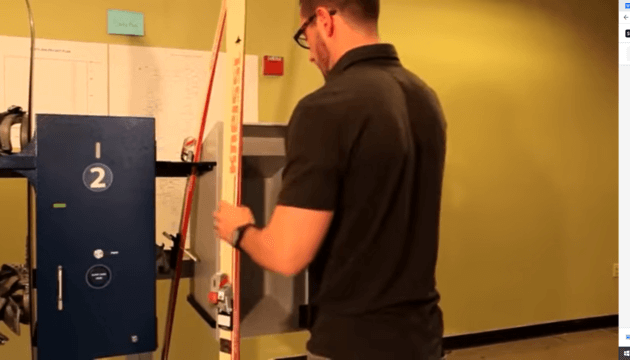 Man working on a snowgate locker kiosk