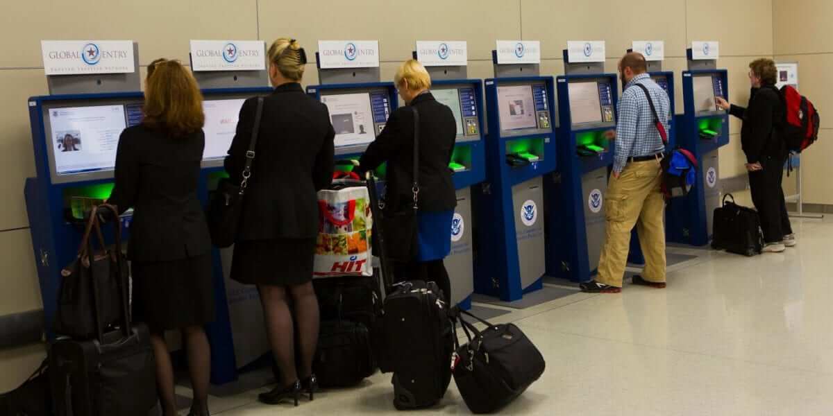 multiple kiosks in use by customers at airport