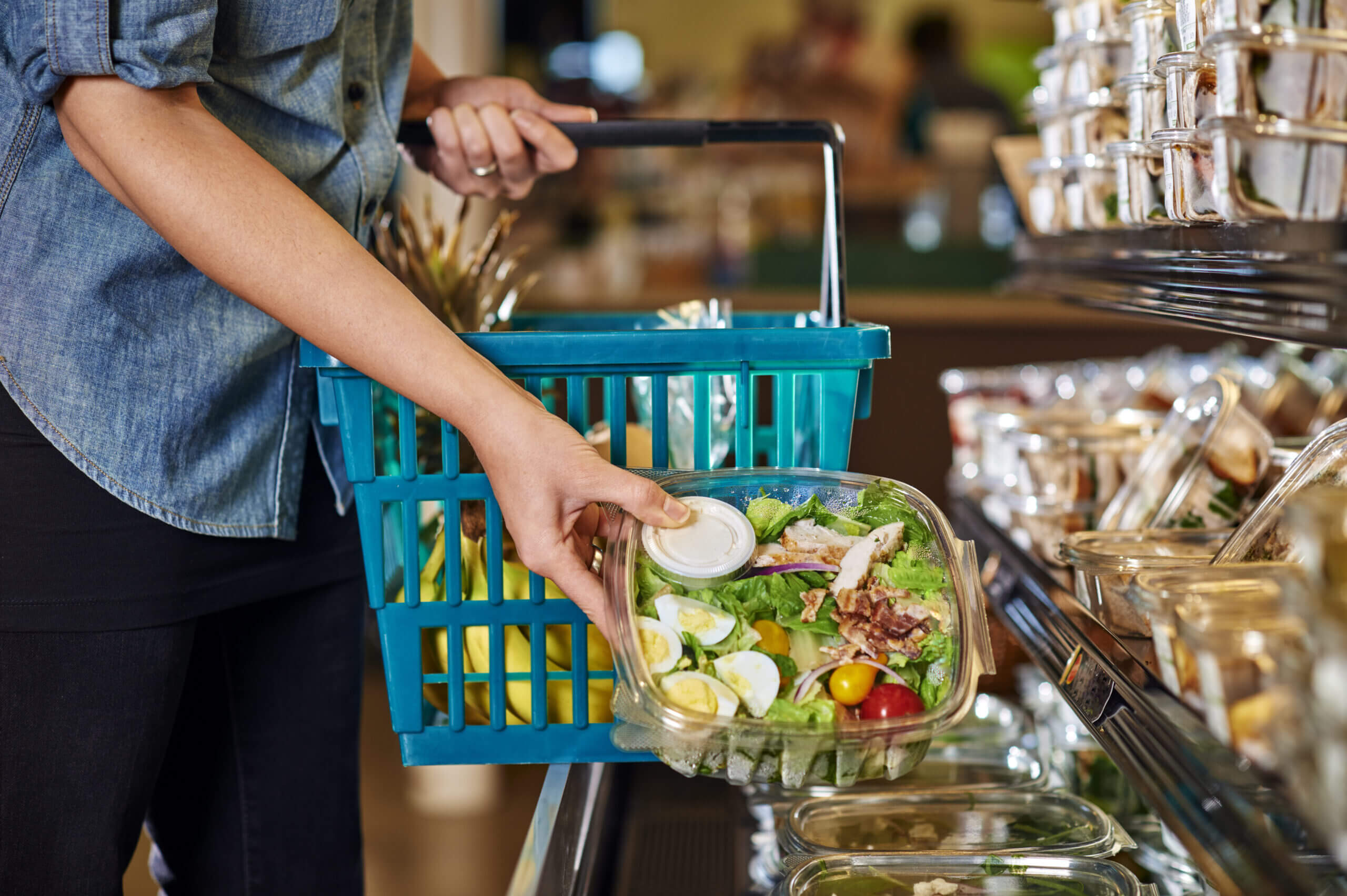 Image of customer checking out at neighborhood grocery or convenience store