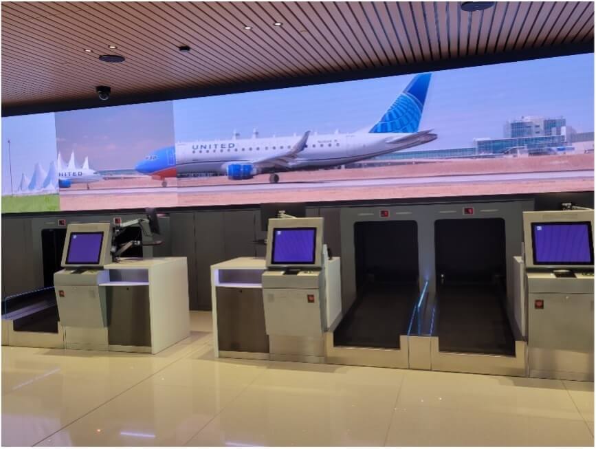 Airport lobby, showcasing checkin kiosk and baggage drop-off