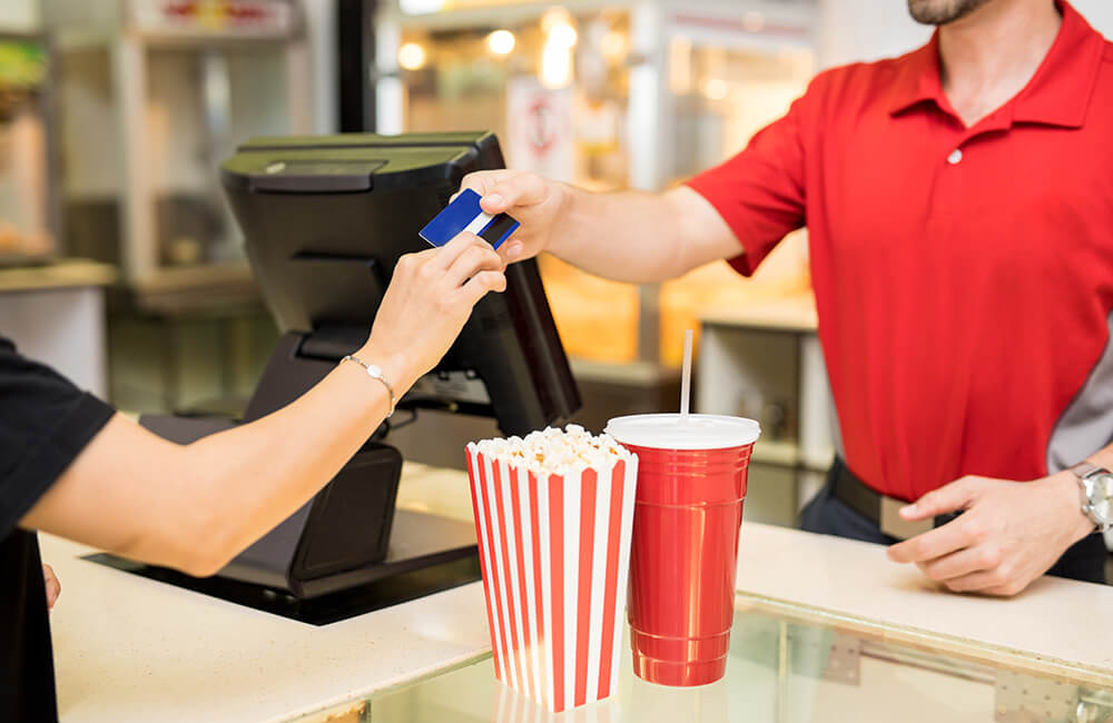 Woman paying for snacks at the movies