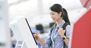 Woman using self check in machine