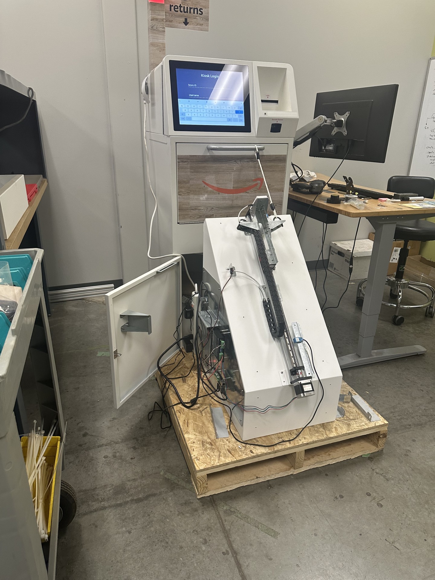 A robotic testing mechanism tests the longevity of a kiosk door.
